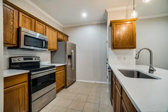 a kitchen with stainless steel appliances granite countertop a sink and a microwave