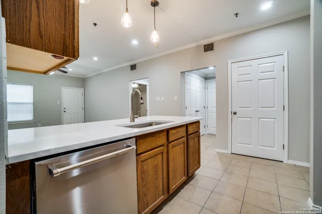 a kitchen with a sink and cabinets