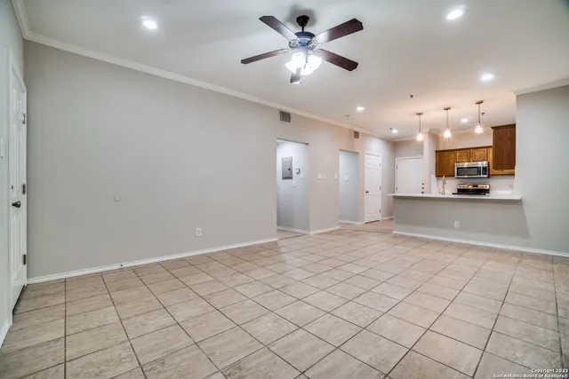 a view of a kitchen with a sink and a refrigerator