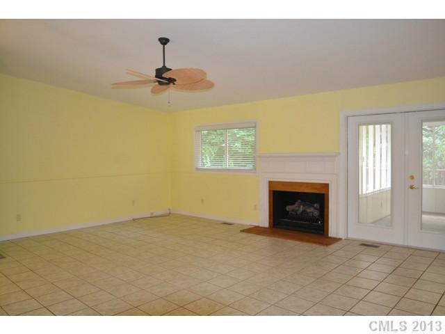 4155 Koala Circle Tega Cay, SC 29708 - Photo 3 of 11 a view of an empty room with a fireplace and a window