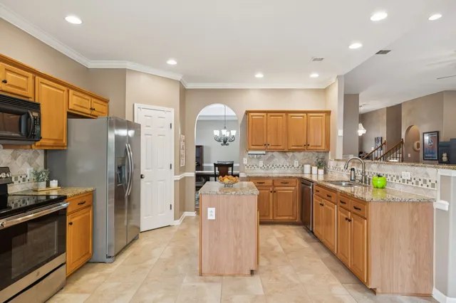 a kitchen with a sink stove and refrigerator