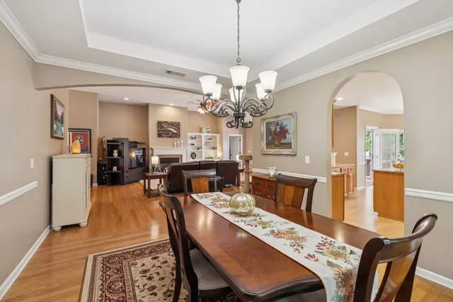 a view of a dining room with furniture and wooden floor