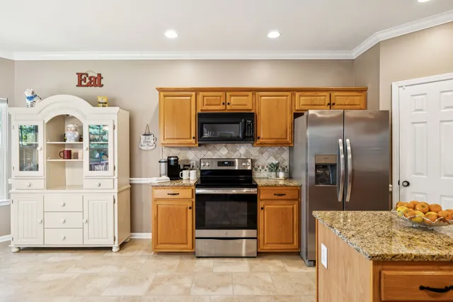 a kitchen with stainless steel appliances granite countertop a stove a refrigerator and a stove