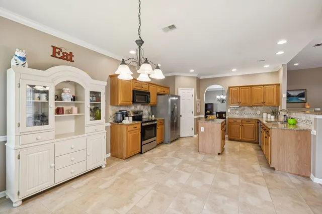 a large kitchen with cabinets and stainless steel appliances