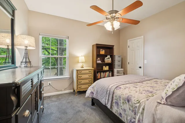a bedroom with a bed dresser and a window