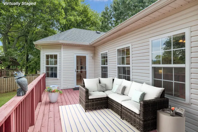 a balcony with wooden floor and furniture