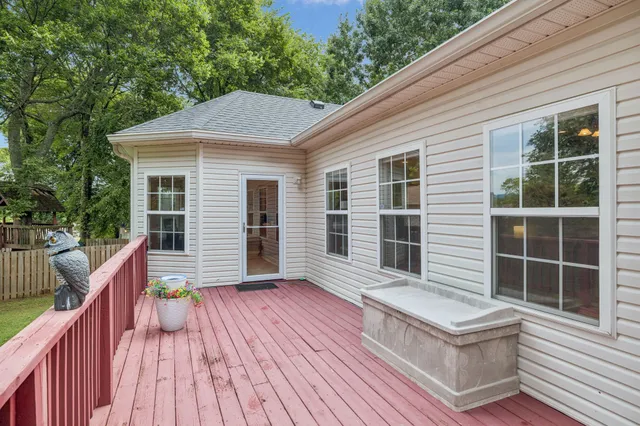 a balcony with wooden floor and fence
