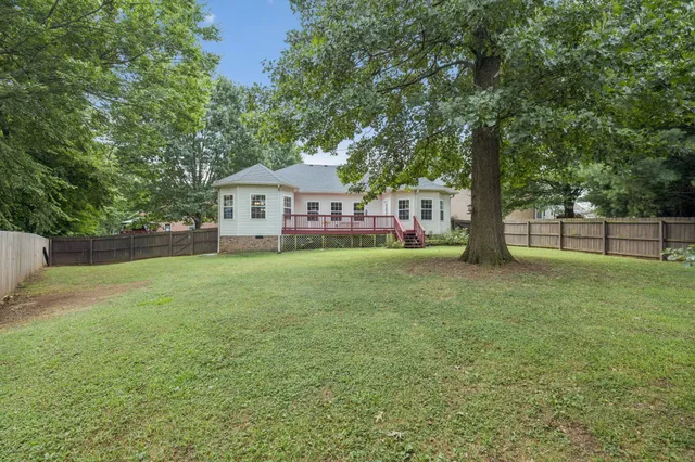 a house with huge green field in front of it