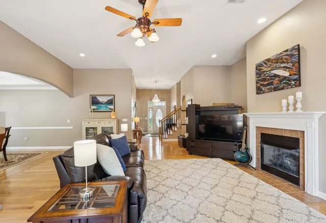 a living room with furniture a flat screen tv and a fireplace