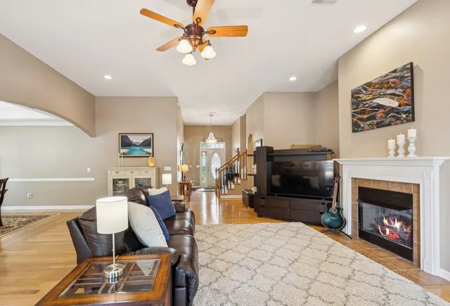 a living room with furniture a flat screen tv and a fireplace