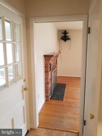 a view of a hallway with a door and stairs