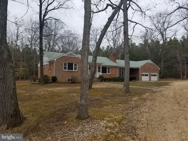 a view of a house with a yard covered in snow