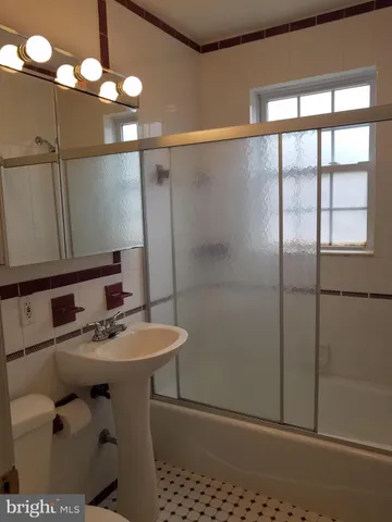a bathroom with a sink a mirror and a shower