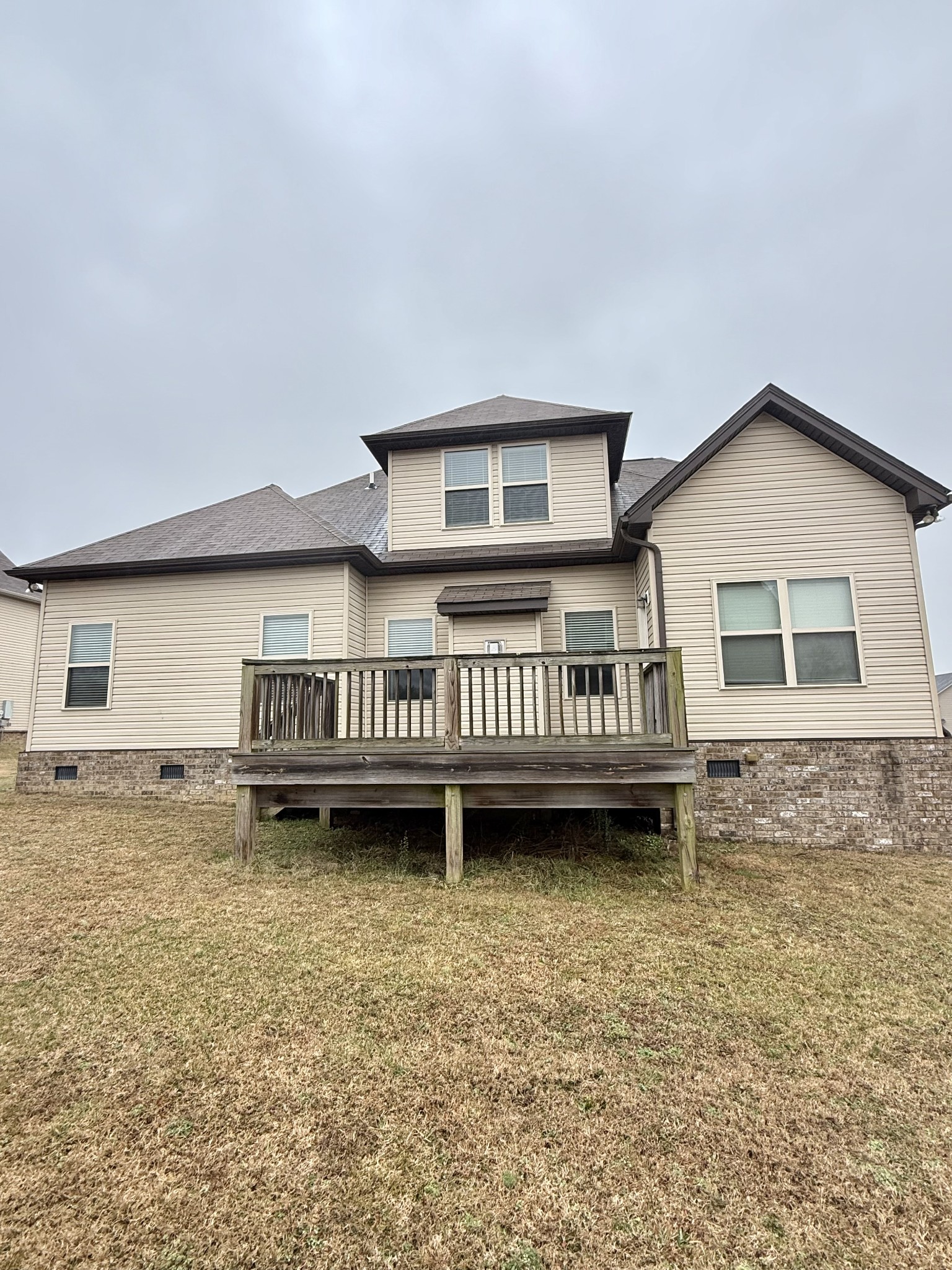 4012 Lexie Lane Spring Hill, TN 37174 - Photo 17 of 38 a view of a house with a wooden deck and a yard