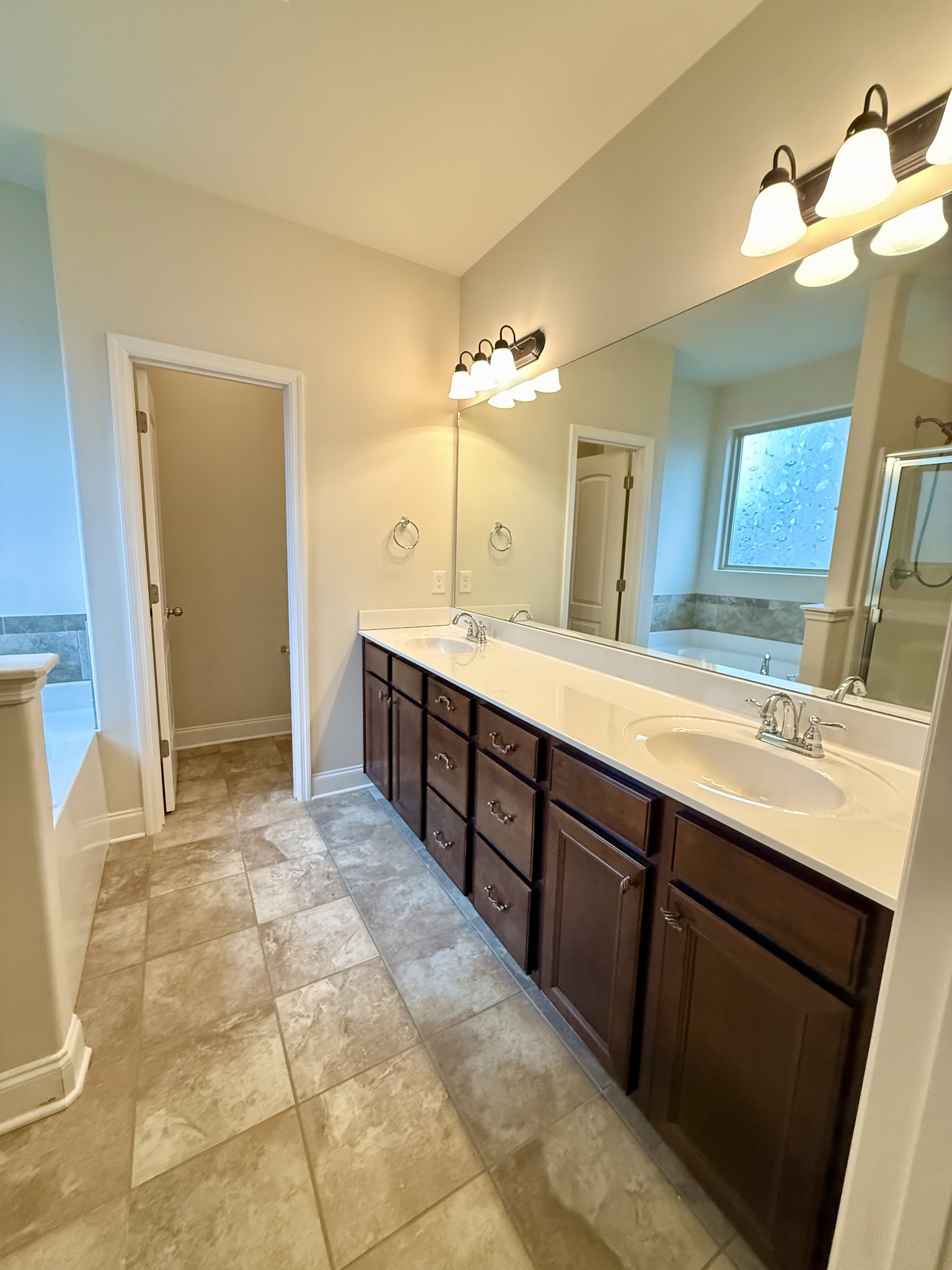 4012 Lexie Lane Spring Hill, TN 37174 - Photo 23 of 38 a spacious bathroom with a double vanity sink a mirror and a shower