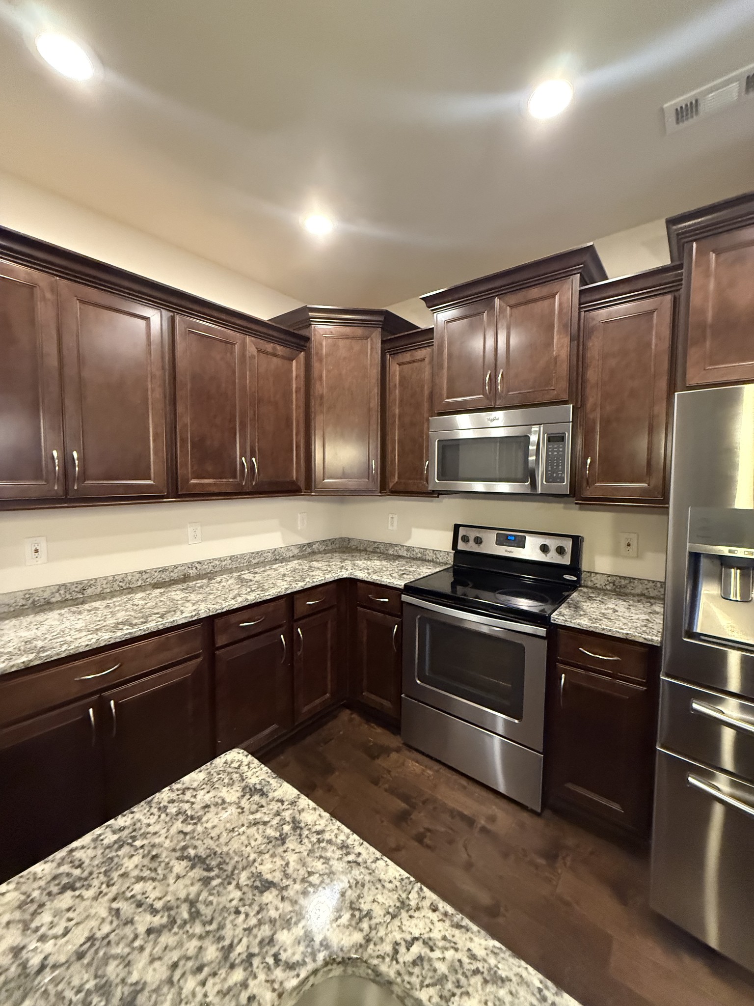 4012 Lexie Lane Spring Hill, TN 37174 - Photo 3 of 38 a kitchen with granite countertop a sink cabinets and stainless steel appliances