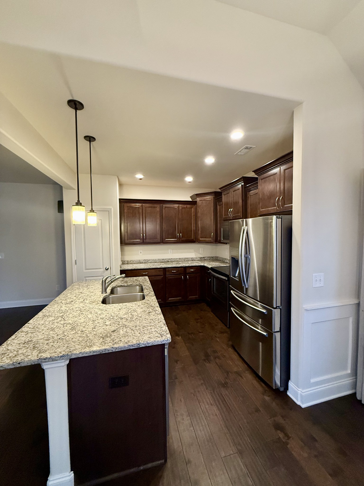 4012 Lexie Lane Spring Hill, TN 37174 - Photo 7 of 38 a kitchen with stainless steel appliances granite countertop a sink refrigerator and microwave