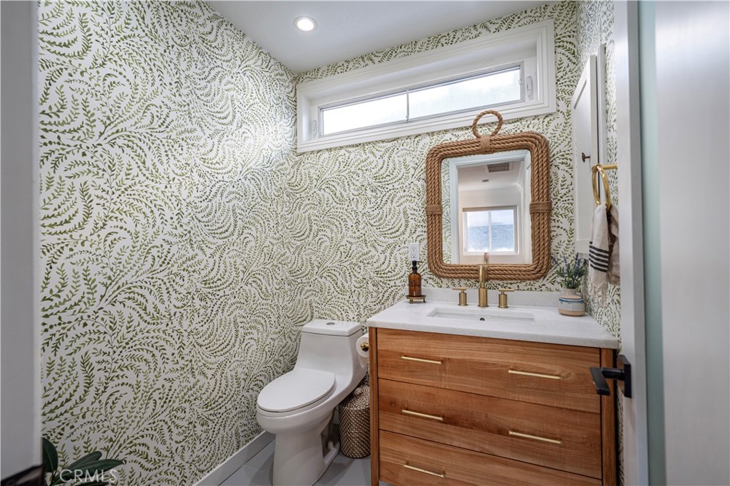 32 56th Place Long Beach, CA 90803 - Photo 15 of 49 a bathroom with a toilet sink and mirror