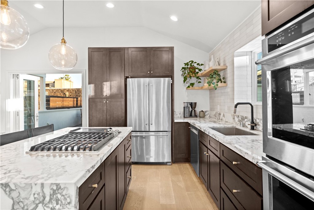 32 56th Place Long Beach, CA 90803 - Photo 7 of 49 a kitchen with a sink stove and refrigerator