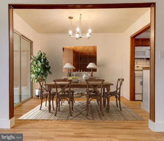 a view of a dining room with furniture and wooden floor
