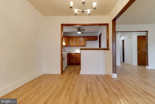 wooden floor in an empty room and a kitchen