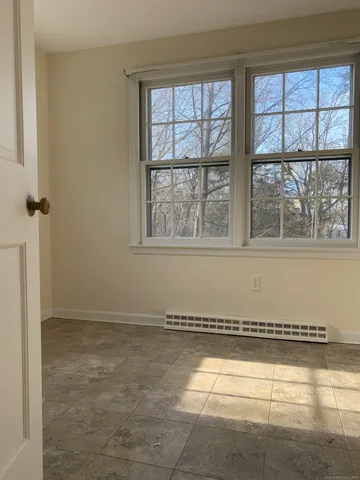 an empty room with a empty space and windows