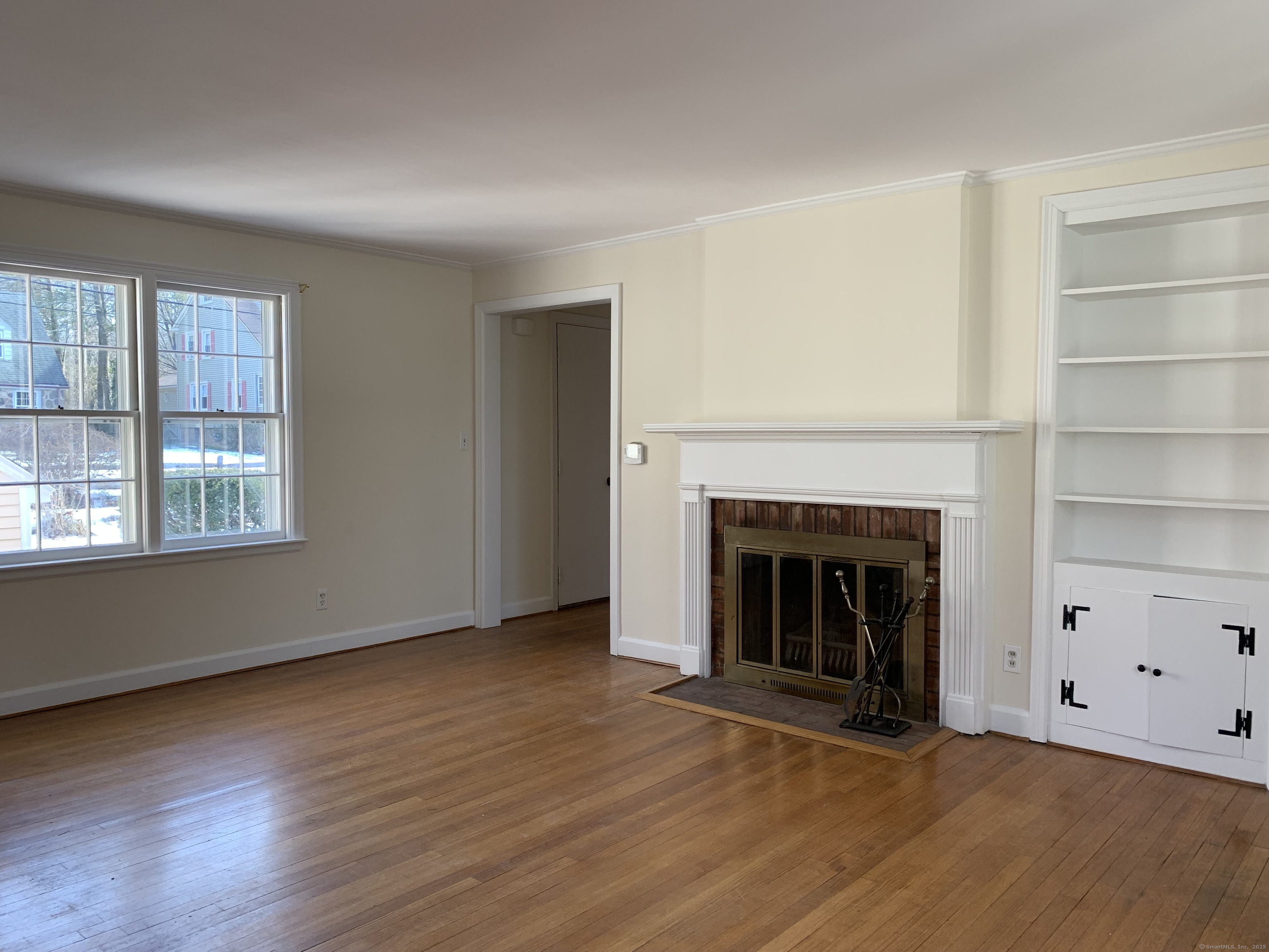 16 Garfield Avenue North Haven, CT 06473 - Photo 13 of 26 an empty room with wooden floor fireplace and windows