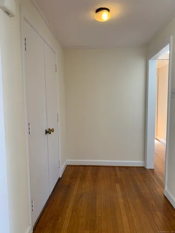a view of a room with wooden floor and white walls