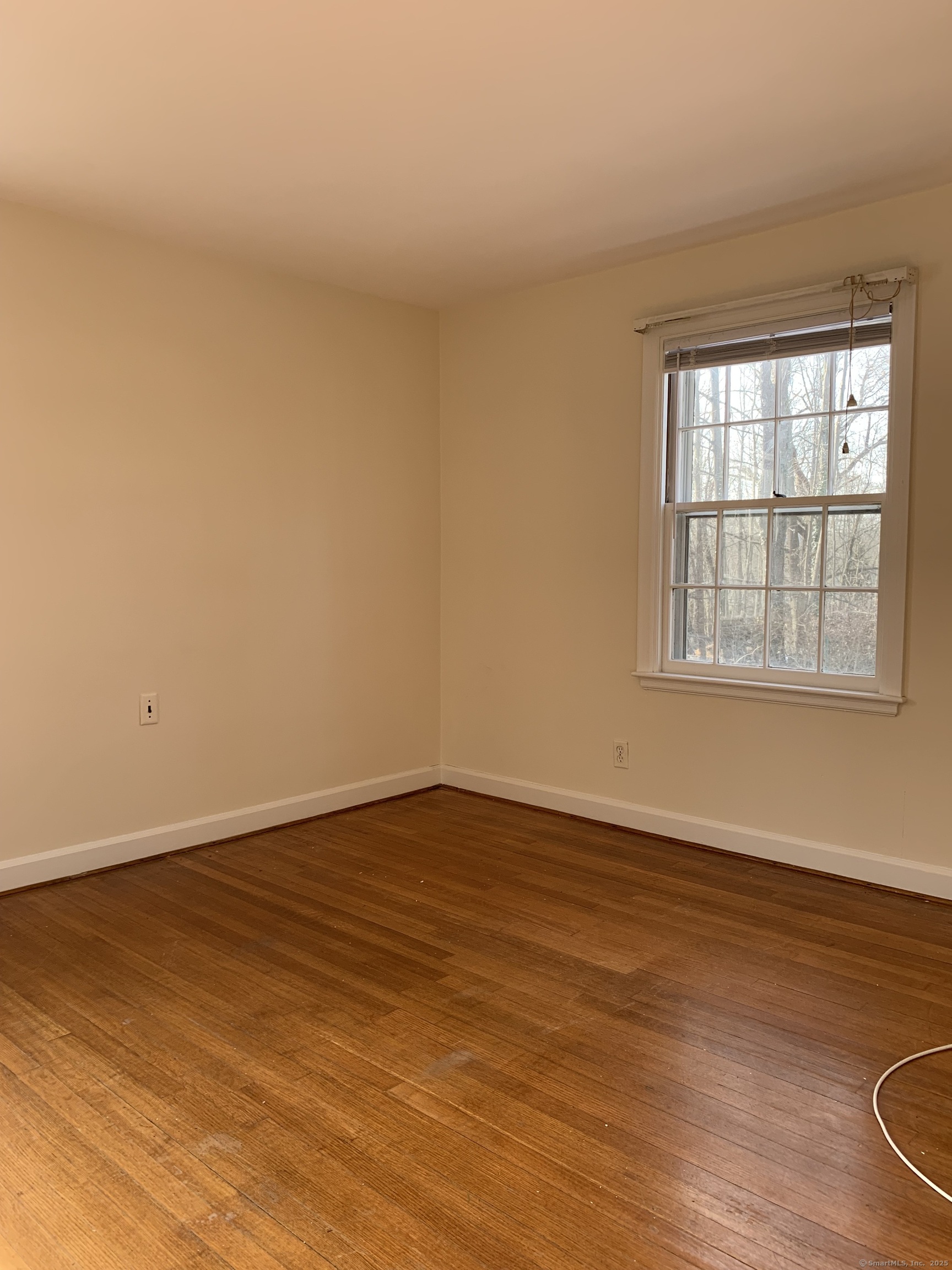 16 Garfield Avenue North Haven, CT 06473 - Photo 20 of 26 a view of an empty room with wooden floor and a window