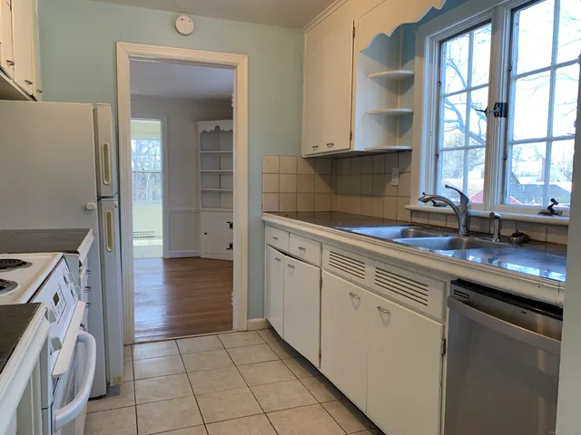 a kitchen with a sink stove and cabinets