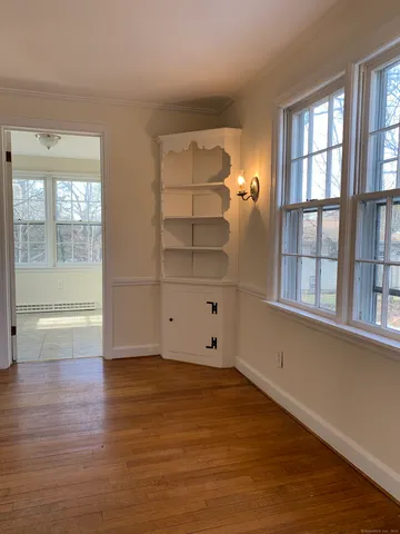 wooden floor in an empty room with a window