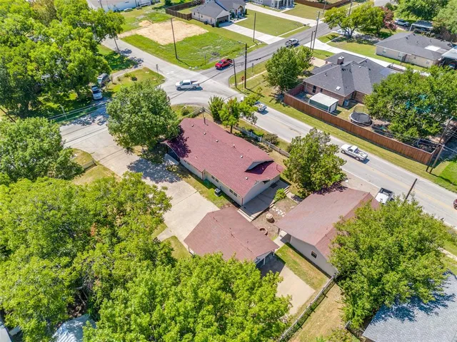 an aerial view of a house with a yard