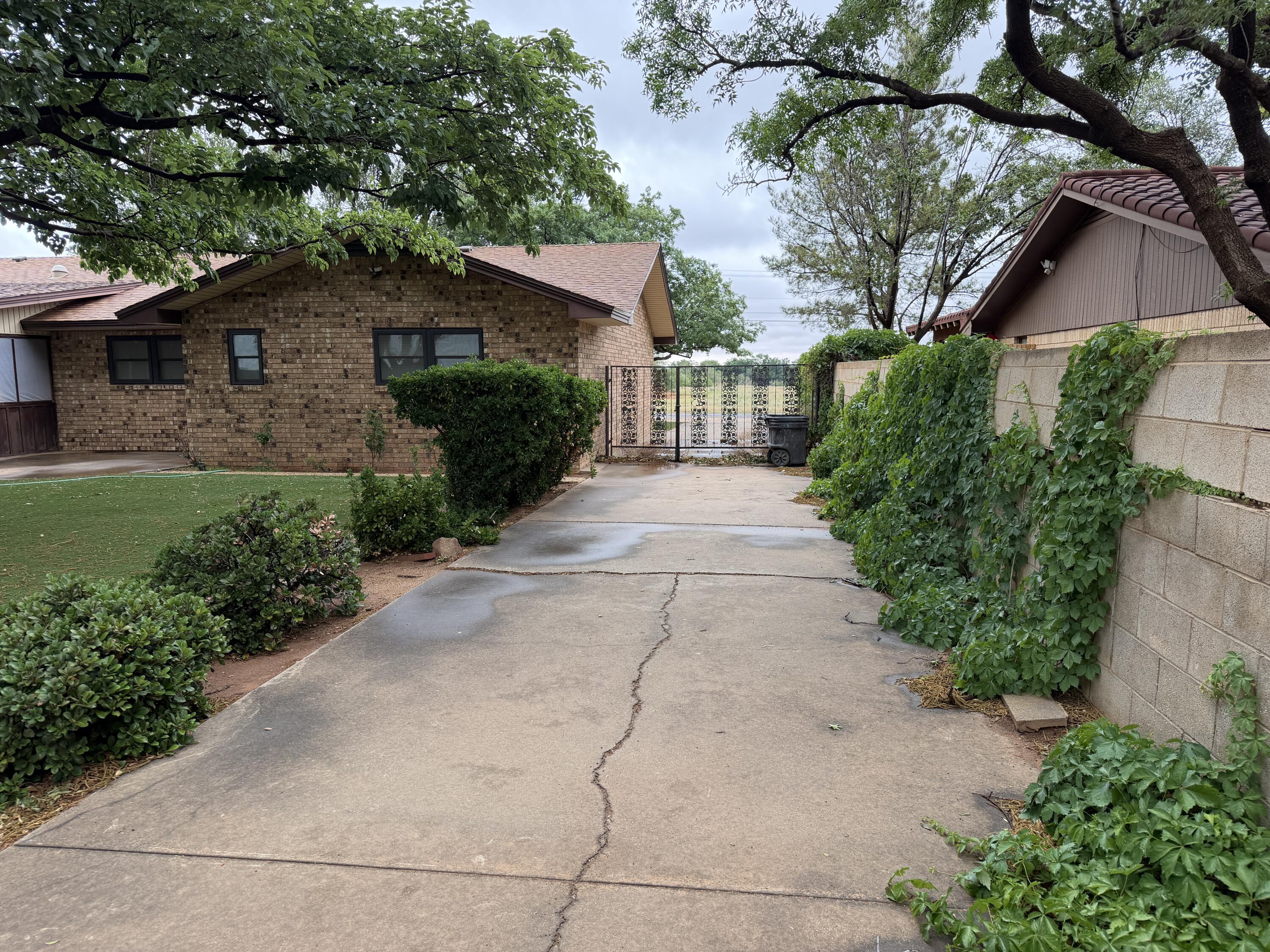1603 South 8th Street Lamesa, TX 79331 - Photo 32 of 39 a backyard of a house with plants and trees