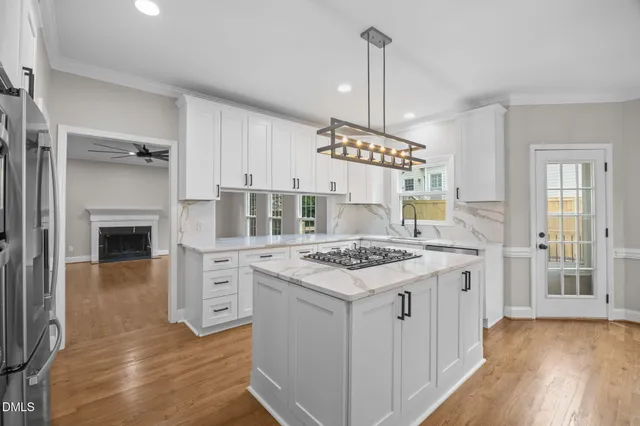 a kitchen with a stove and a wooden floors