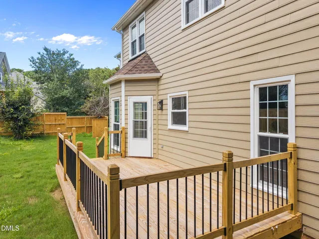 a view of a house with backyard and deck