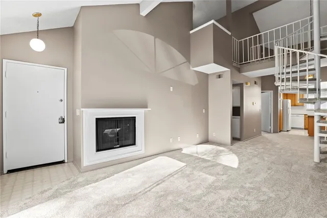 a view of entryway and hall with a fireplace