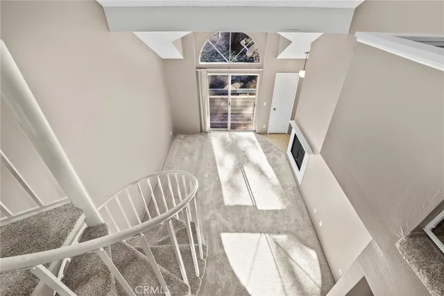 a view of a bedroom with wooden floor and stairs