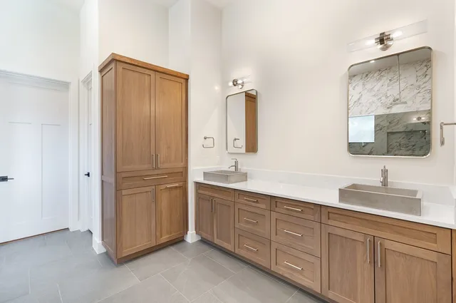 a bathroom with a double vanity sink and mirror