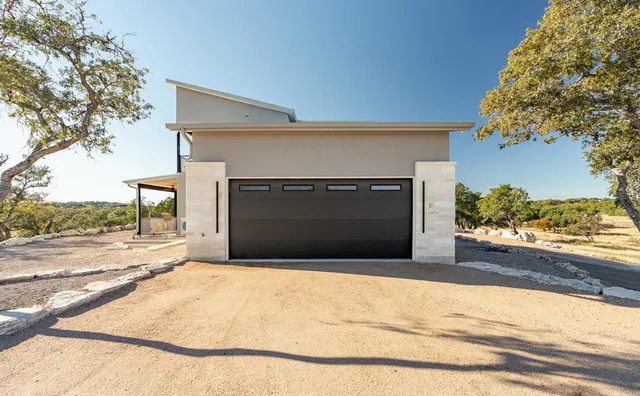 a view of a dry yard with green space