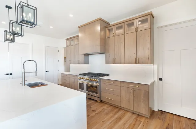 a kitchen with a stove a sink and a refrigerator