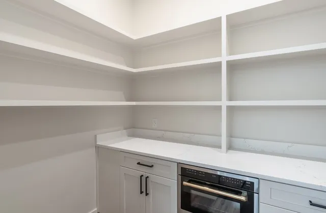 a swimming pool with a large mirror and potted plants