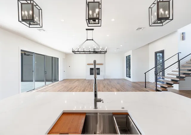 a view of a room with wooden floor and windows