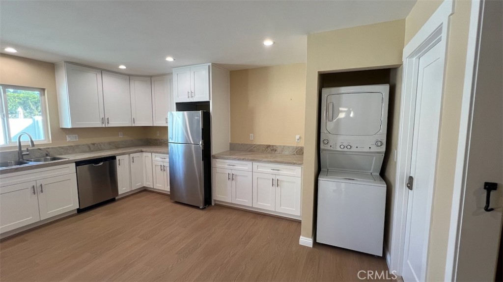 10908 Canby Avenue Porter Ranch, CA 91326 - Photo 11 of 26 a kitchen with a refrigerator sink and cabinets