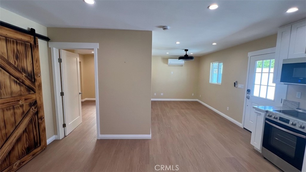 10908 Canby Avenue Porter Ranch, CA 91326 - Photo 12 of 26 wooden floor in an empty room with a fireplace