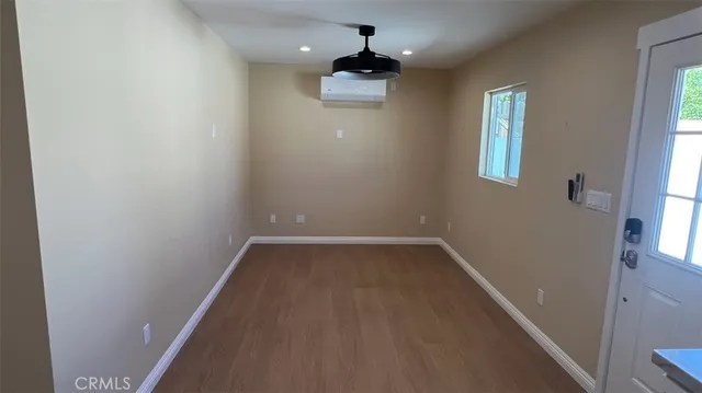 wooden floor in an empty room with a window