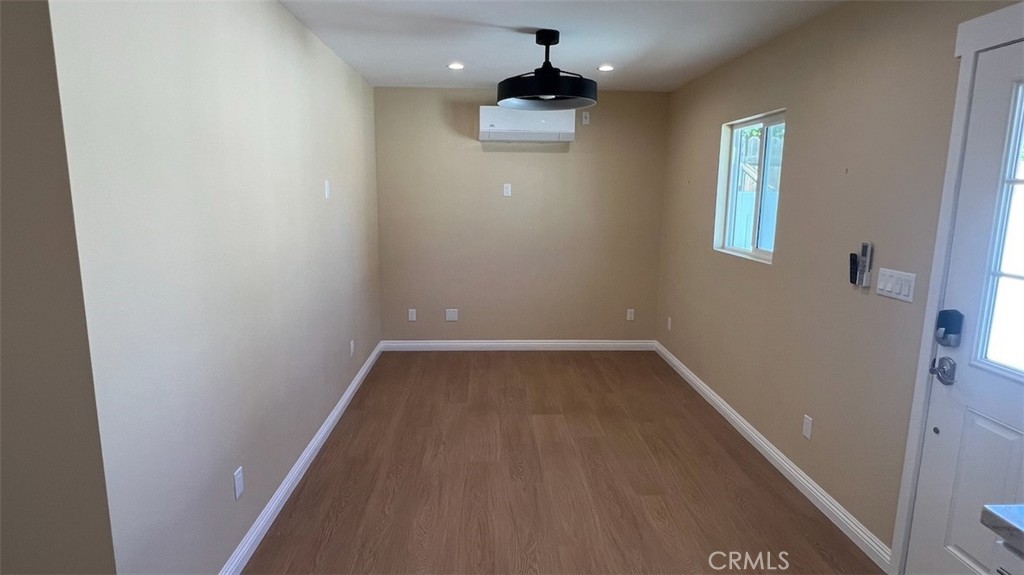 10908 Canby Avenue Porter Ranch, CA 91326 - Photo 15 of 26 a view of a hallway with wooden floor and a chandelier