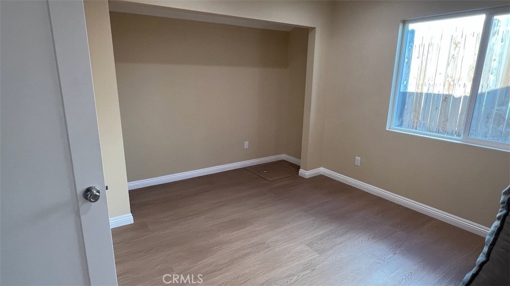 10908 Canby Avenue Porter Ranch, CA 91326 - Photo 19 of 26 an empty room with wooden floor and windows