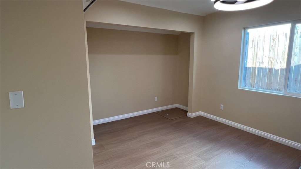 10908 Canby Avenue Porter Ranch, CA 91326 - Photo 20 of 26 an empty room with wooden floor and windows