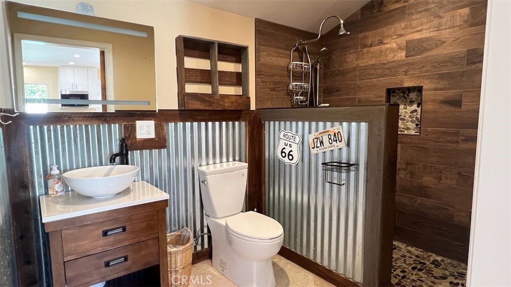 10908 Canby Avenue Porter Ranch, CA 91326 - Photo 21 of 26 a bathroom with a toilet a sink and a mirror