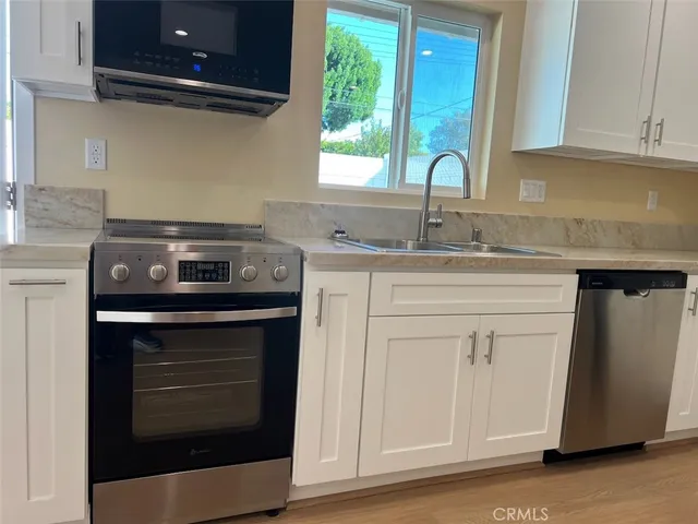 a kitchen with a sink and cabinets